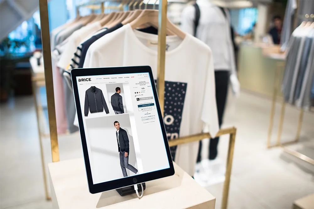 A Fitizzy kiosk standing in the aisle of a clothing store